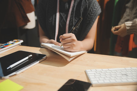 Fashion designers at work. beautiful young woman working in fashion design studio.の写真素材