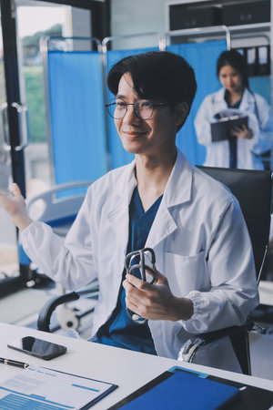 Positive doctor working on laptop in medical office.の写真素材