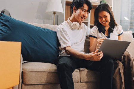 Smiling couple unpacking boxes in new houseの写真素材
