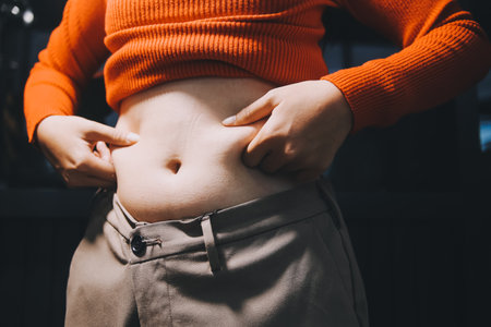 woman's hand holding belly fatの写真素材