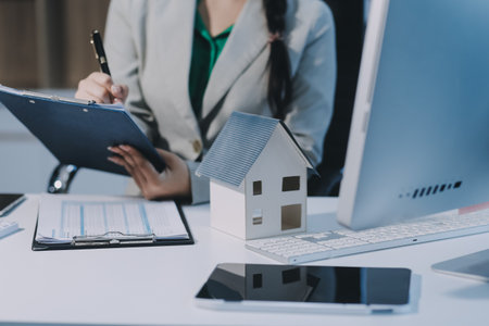 Home and real estate trading business. Real estate agent giving keys to house woman owner.の写真素材