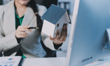 Real estate agent giving keys to house woman owner.の写真素材