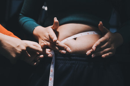 woman's hand holding belly fatの写真素材