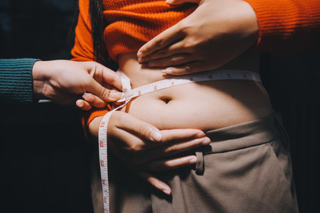 woman's hand holding belly fatの写真素材