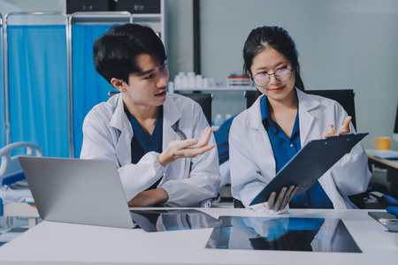 Positive doctors working on laptop in medical office, portrait.の写真素材