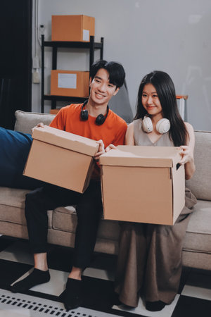 Smiling couple unpacking boxes in new houseの写真素材