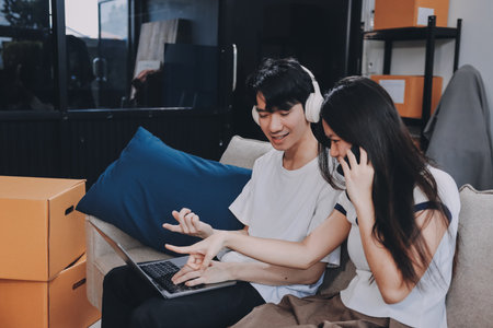 Smiling couple unpacking boxes in new houseの写真素材