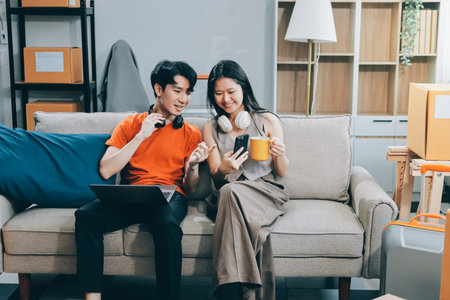 Smiling couple unpacking boxes in new house