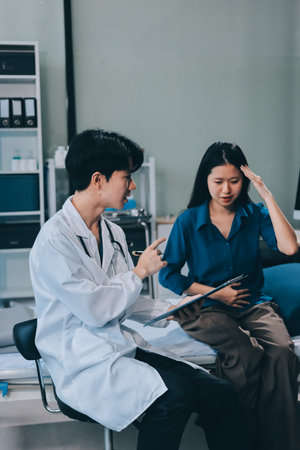 doctor consulting senior old patient filling form at consultation. Professional physician wearing...