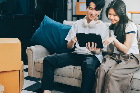 Smiling couple unpacking boxes in new houseの写真素材