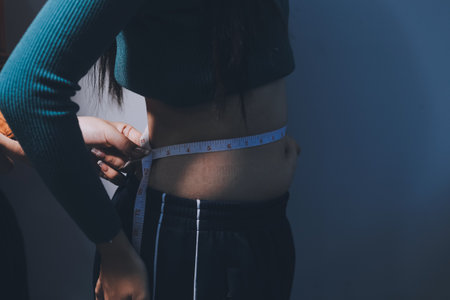 Woman Pinching Her Belly Fat With Left Hand