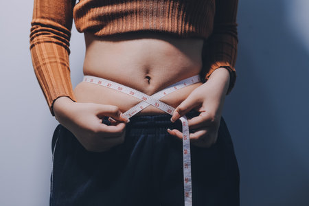 Asian Woman Pinching Her Bellyの写真素材