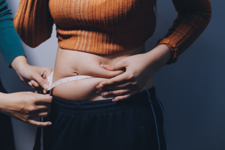 Asian Woman Pinching Her Belly With Left Handの写真素材