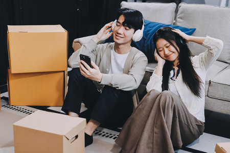 Smiling couple unpacking boxes in new houseの写真素材