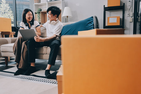 Smiling couple unpacking boxes in new houseの写真素材