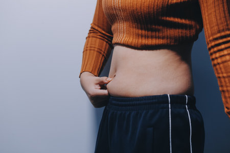 Asian Woman Pinching Her Belly With Left Handの写真素材