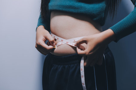 Asian Woman Pinching Her Bellyの写真素材