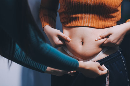 Asian Woman Pinching Her Bellyの写真素材