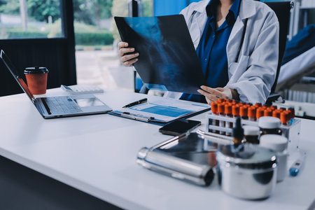 Positive doctor working on laptop in medical office, portrait.の写真素材