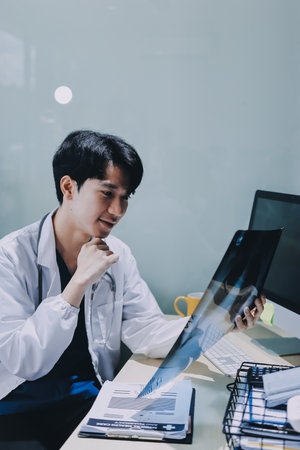 Positive doctor working on laptop in medical office, portrait.の写真素材
