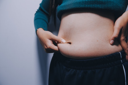 Asian Woman Pinching Her Belly With Left Handの写真素材