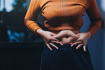 Woman Pinching Her Belly With Left Handの写真素材