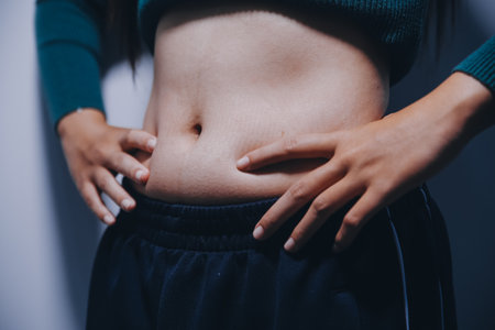 Asian Woman Pinching Her Belly With Left Handの写真素材