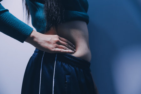 Asian Woman Pinching Her Belly With Left Hand
