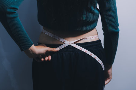 Asian Woman Pinching Her Belly With Left Handの写真素材