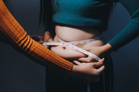 Asian Woman Pinching Her Belly With Left Handの写真素材