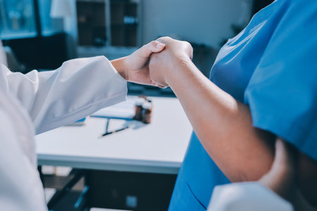 Orthopedist examining patient in hospitalの写真素材