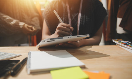 Fashion designers at work. beautiful young woman working in fashion design studio.の写真素材