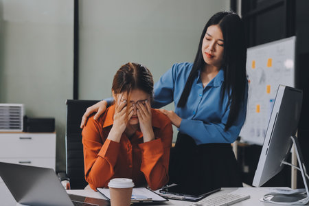 Asian women are stressed or has sore throat at office while working on laptop, Tired asian...