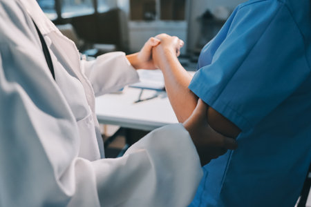 Orthopedist examining patient in hospitalの写真素材