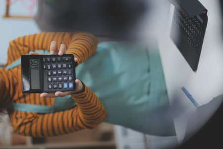 vlogger, blogger small SME business asian beautiful woman using mobile phone video call for sell clothes live stream selling online, show product present detail at home office, entrepreneur ecommerceの写真素材