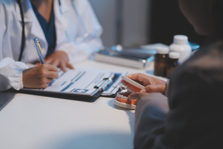 Dentist and patient discussion about planned dental treatment in dental clinic office, doctors talk and work. health care talk medical conference conceptの写真素材