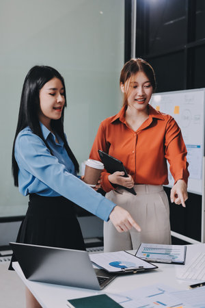 Entrepreneurs and business people conference in modern meeting room, happy multiracial coworkers have fun cooperating working together at office meeting, asian teamwork conceptの写真素材