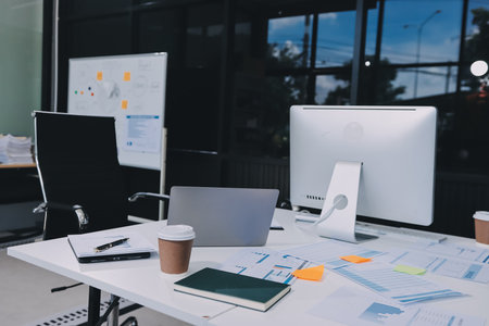 Entrepreneur Asian businessman and businesswoman discussing new business project in tablet in modern Meeting In Modern Office, Asian business casual concept.の写真素材