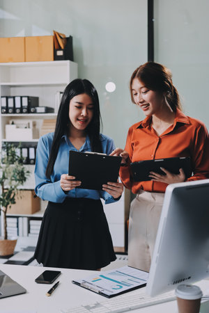 Entrepreneurs and business people conference in modern meeting room, happy multiracial coworkers have fun cooperating working together at office meeting, asian teamwork conceptの写真素材