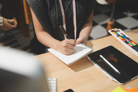 Fashion designers at work. beautiful young woman working in fashion design studio.の写真素材