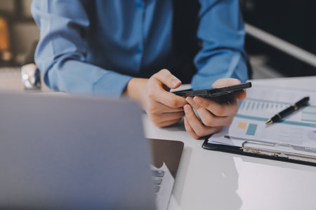 Entrepreneur Asian businessman and businesswoman discussing new business project in tablet in modern...