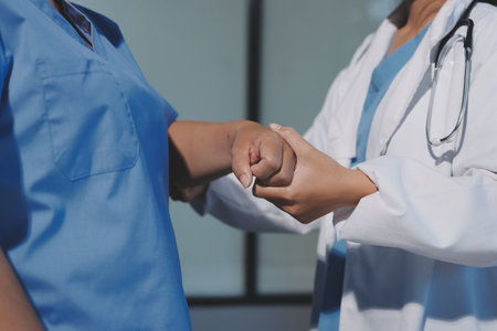 Orthopedist examining patient in hospitalの写真素材