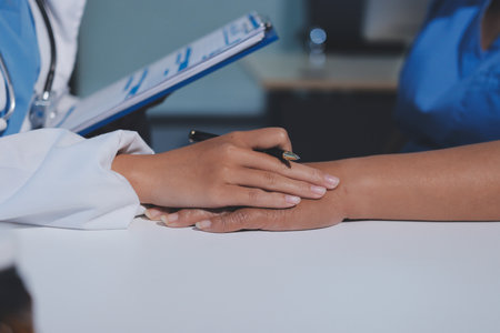 Closeup, doctor holding hands with senior woman and cancer care or support. Healthcare or trust, empathy or compassion and female caregiver or nurse holding elderly person hand for hope and kindnessの写真素材