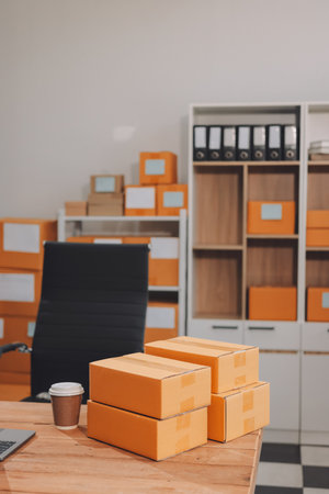 Asian SME business women use laptop computer checking customer order online shipping boxes at home. Starting Small business entrepreneur SME freelance. Online business, Work at home concept.の写真素材