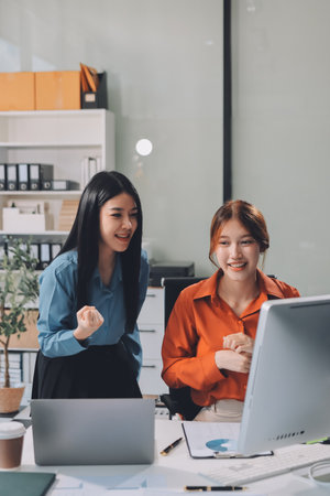 Group of Young Asian business team creative businesspeople coworker in office Happy to be successful partnership teamwork celebrating achievement and success concept.の写真素材