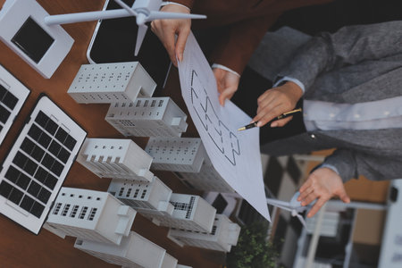 Discussion among businesspeople on the latest developments in solar cell panel technology and Solar Energy Environment city Concept.の写真素材