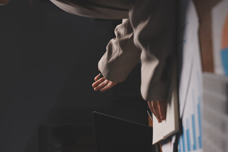 A person points to a graph on a piece of paper.の写真素材