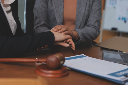 Judge gavel with Justice lawyers having team meeting at law firm background. Concepts of Law and Legal services.の写真素材