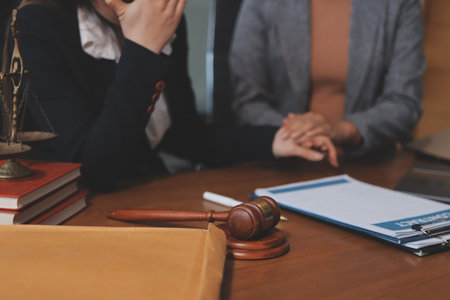 Judge gavel with Justice lawyers having team meeting at law firm background. Concepts of Law and...
