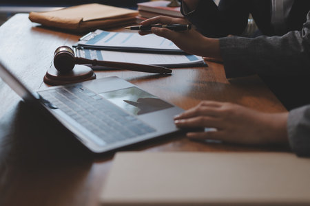 Judge gavel with Justice lawyers having team meeting at law firm background. Concepts of Law and Legal services.の写真素材